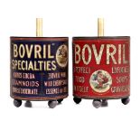 TWO VINTAGE 'BOVRIL' ADVERTISING TINS CONVERTED INTO LAMPS standing on bun feet, 73cm high