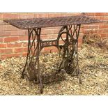 A GARDEN OR CONSERVATORY TABLE with pierced rectangular top and base constructed from a treadle