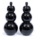 A PAIR OF CONTEMPORARY BLACK GLASS TABLE LAMPS OF TRIPLE GOURD FORM each 22cm wide x 55cm high