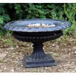 A VICTORIAN BLACK PAINTED CAMPANA URN of shallow form with egg and dart decoration to the rim and