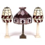 A PAIR OF TURNED ALABASTER TABLE LAMPS of column form with leaded coloured glass shades 70cm high