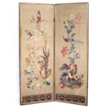 AN ANTIQUE EMBROIDERED TWO FOLD SCREEN decorated with butterflies and floral scenes on linen and