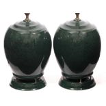 A PAIR OF LATE 20TH CENTURY / EARLY 21ST CENTURY GREEN PAINTED CERAMIC LAMPS with integrated