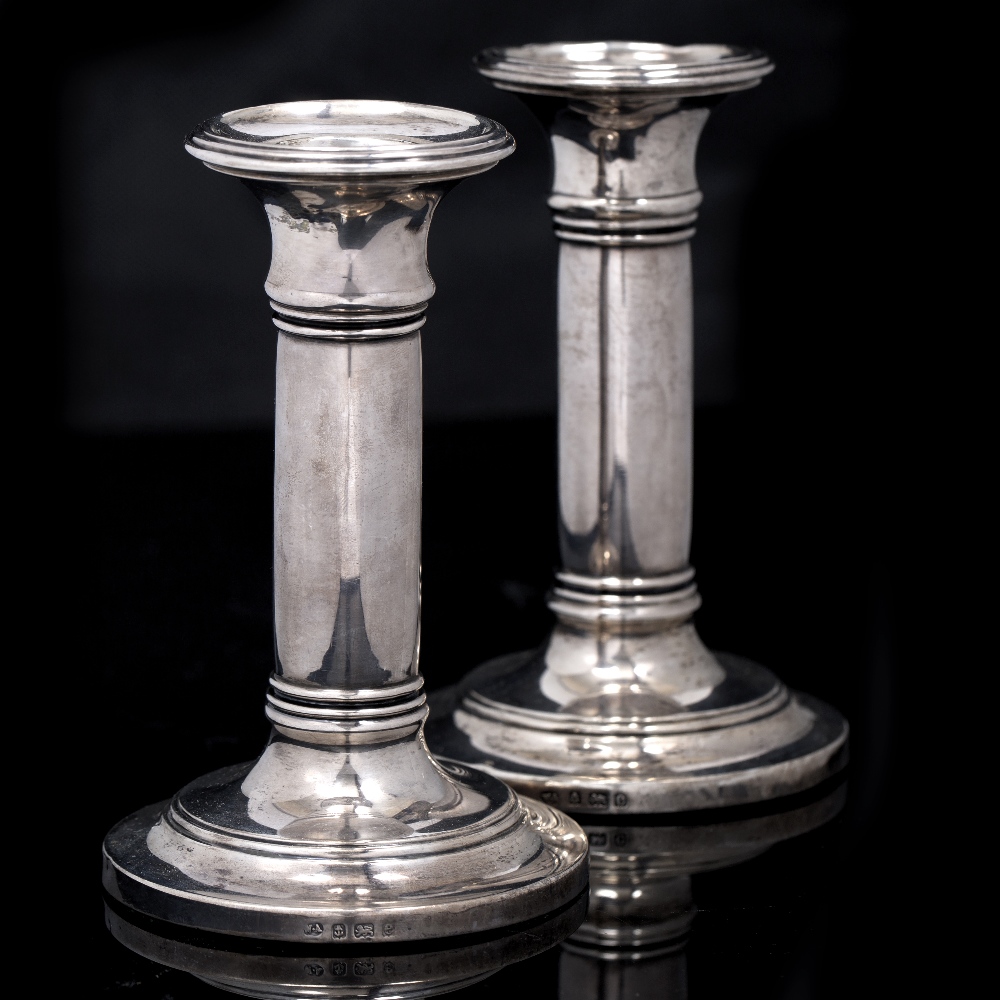 A PAIR OF SILVER DWARF CANDLESTICKS of cylindrical form on stepped spreading circular bases, with
