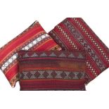 THREE OLD BEDOUIN CUSHIONS all approximately 70cm x 40cm (3)