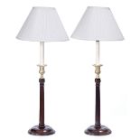 A PAIR OF GEORGIAN STYLE TABLE LAMPS with fluted stems and circular spreading bases standing 65cm