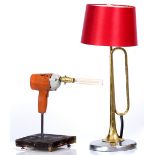 A TABLE LAMP constructed from a brass horn and a chrome plated hub cap 70cm high overall including