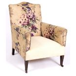 A VICTORIAN ARMCHAIR with square tapering front legs and floral decorated upholstery, 72cm wide x