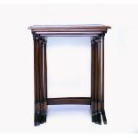 A GEORGIAN STYLE MAHOGANY NEST OF FOUR OCCASIONAL TABLES on delicately turned legs, the largest 58cm