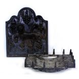 A REPRODUCTION 20TH CENTURY CAST IRON FIREBACK decorated with a lion amongst flowers with a