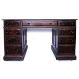 A MAHOGANY PARTNERS DESK with a red leather inset top and nine drawers with turned knob handles