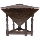 AN ANTIQUE OAK TRIANGULAR DROP LEAF OCCASIONAL GATELEG TABLE of pegged construction, 87cm wide x