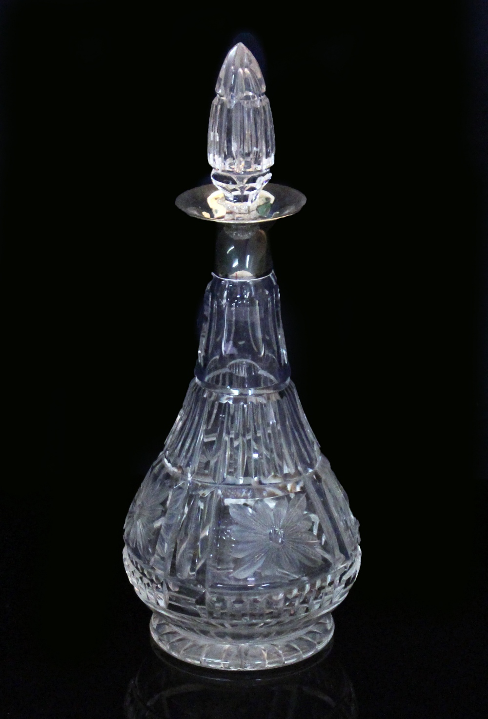 A 20TH CENTURY CUT GLASS WINE DECANTER with silver collar and cut glass stopper, 33cm high overall