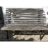 AN LM FURNITURE BENCH with teak slats and cast iron ends numbered LM485-6, 122cm wide x 68cm deep