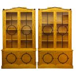 A PAIR OF ART DECO STYLE BIRCHWOOD BOOKCASE CABINETS BY RUPERT CAVENDISH of architectural form,