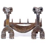 A CAST IRON FIRE GRATE the supports decorated with rams head masks and cloven hoof feet 72cm wide