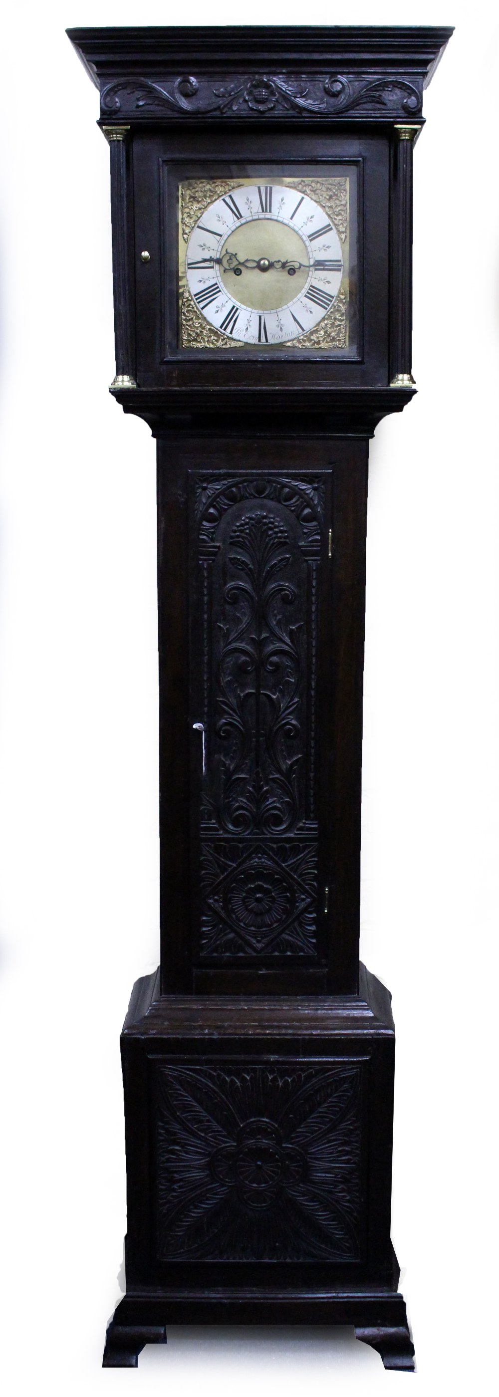 AN OLD EIGHT DAY LONG CASE CLOCK with chip carved decoration to the case, and with brass dial with