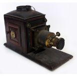 A VICTORIAN MAGIC LANTERN with brass lens converted for electricity together with a quantity of