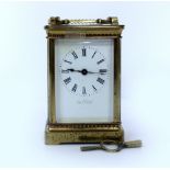 A LATE 19TH / EARLY 20TH CENTURY FRENCH BRASS CARRIAGE CLOCK with white enamel dial marked 'The