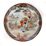 A 20TH CENTURY JAPANESE PORCELAIN CHARGER decorated with figures in a landscape, 36.5cm