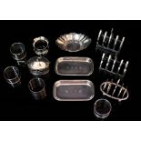 TWO SILVER FOUR DIVISION TOAST RACKS a group of five silver napkin rings, a silver mustard pot