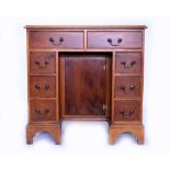 A GEORGIAN STYLE YEW WOOD KNEE HOLE DESK with leather inset top, 76.5cm wide x 51cm deep x 75.5cm