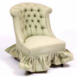 A VICTORIAN GREEN BUTTON UPHOLSTERED LOW OCCASIONAL CHAIR with turned ebonised front legs, 62cm wide