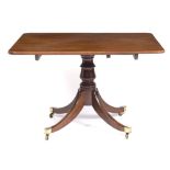 A GEORGE III MAHOGANY RECTANGULAR TILT TOP BREAKFAST TABLE with turned column support and four sabre