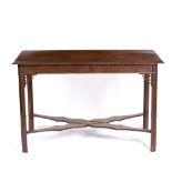 AN ANTIQUE MAHOGANY RECTANGULAR TOPPED SIDE TABLE with square legs united by a shaped 'X' stretcher,