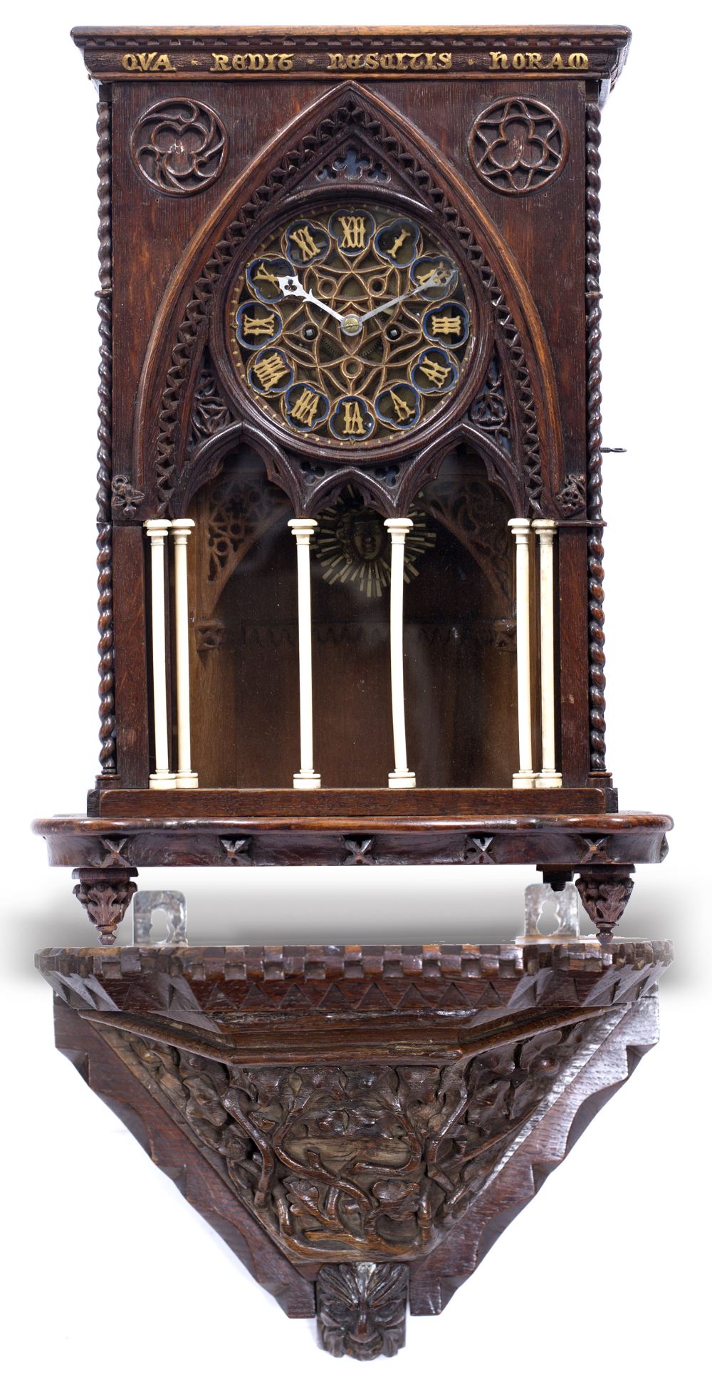 AN OAK GOTHIC REVIVAL BRACKET CLOCK with chip carved decoration to the case and with outset turned