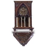 AN OAK GOTHIC REVIVAL BRACKET CLOCK with chip carved decoration to the case and with outset turned