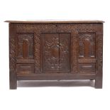 A LATE 17TH CENTURY OAK COFFER of pegged construction with chip carved panel front and candle box