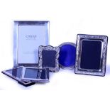 TWO CARRS SILVER PICTURE FRAMES the largest 22cm x 17cm together with four further silver picture