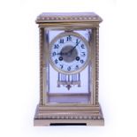A LATE 19TH / EARLY 20TH CENTURY BRASS CASED MANTLE CLOCK with white enamelled dial and Arabic