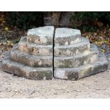 AN OLD CARVED STONE STEPPED OCTAGONAL PLINTH BASE in two sections 91cm wide x 30cm high