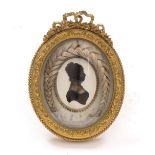 AN EMPIRE LOUIS PHILIPPE I OVAL ORMOLU FRAMED SILHOUETTE OF A LADY with initials and dated 24th