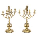 A PAIR OF OLD DUTCH BRASS FOUR LIGHT CANDELABRA with scrolling arms, central lion finials supporting