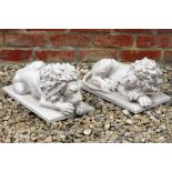 A PAIR OF COMPOSITE ARTS STUDIO STATUES depicting resting lions each 39cm in length