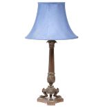 A CLASSICALLY INSPIRED CAST BRASS TABLE LAMP with reeded column support, the triform base with paw