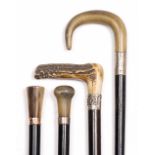A GROUP OF FOUR ANTIQUE HORN AND ANTLER MOUNTED WALKING STICKS AND CANES one with a gold collar, the