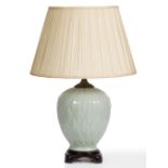 A CELADON GLAZED TABLE LAMP moulded as an acanthus flower 23cm diameter x 45cm high to the fitting`