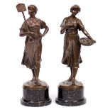 A PAIR OF 19TH CENTURY CONTINENTAL BRONZE FEMALE FIGURES one carrying a spade, the other a basket of