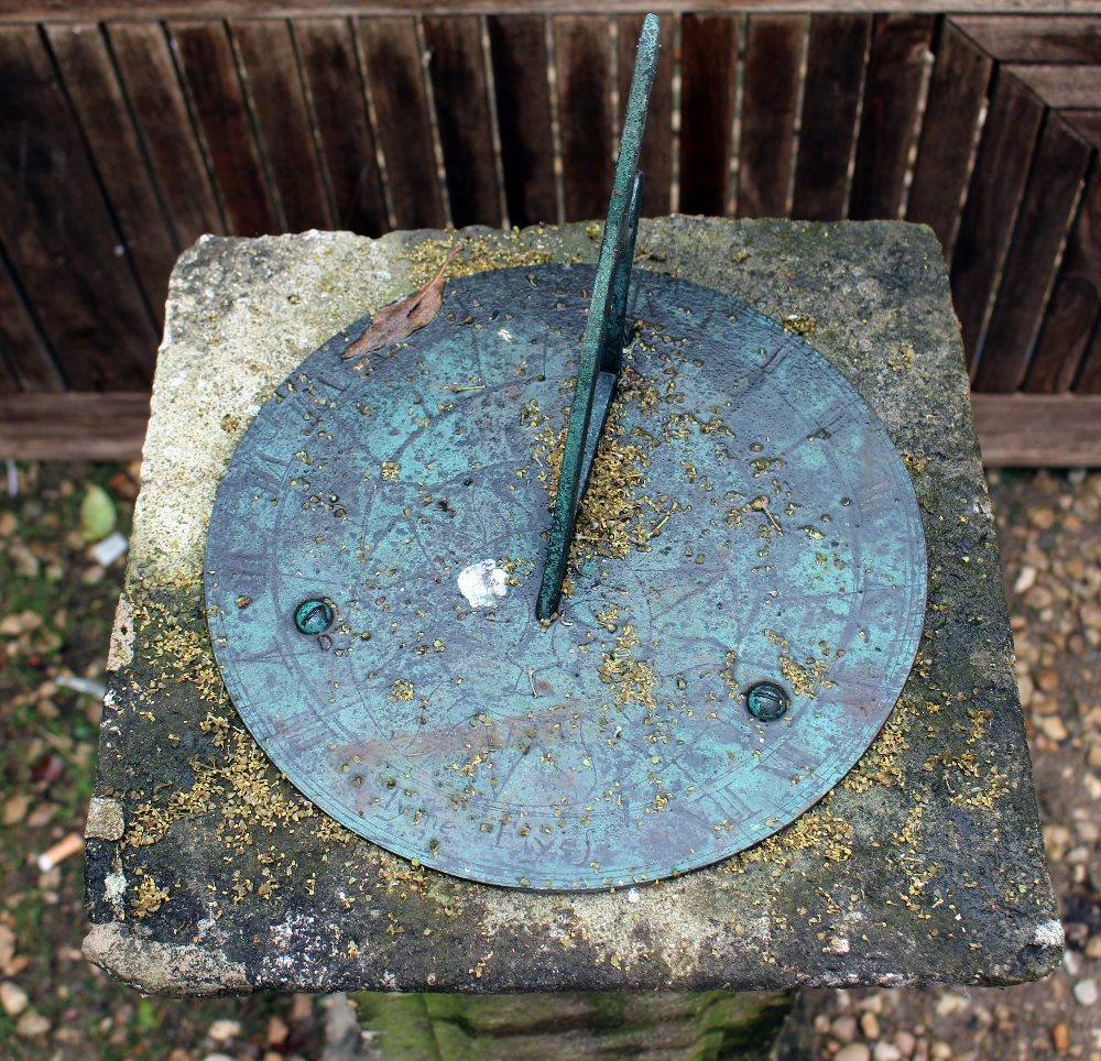 A CARVED STONE SUNDIAL of square plinth form with bronze dial plate, panelled column and on a - Image 2 of 2