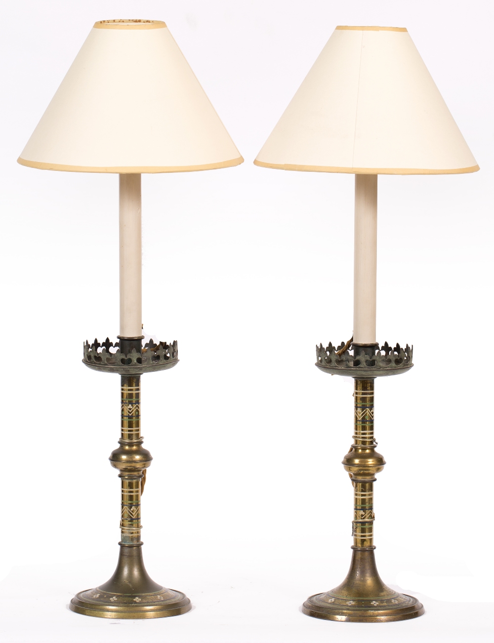 A PAIR OF VICTORIAN BRASS GOTHIC REVIVAL CANDLESTICKS with painted flowerhead and line decoration,