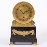 A GEORGE IV GILT BRONZE AND BLACK SLATE MANTLE TIMEPIECE the engine turned drum on scroll supports