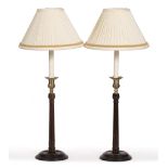 A PAIR OF GEORGIAN STYLE HARDWOOD TABLE LAMPS with fluted stems and circular spreading bases 65cm