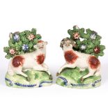 A PAIR OF EARLY 19TH CENTURY STAFFORDSHIRE ORNAMENTS in the form of a ram and a sheep beneath a