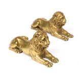 A PAIR OF CAST ORMOLU LION ORNAMENTS 15.5cm long x 7.5cm high