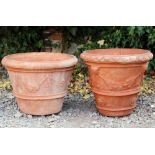 A TERRACOTTA PLANTER of cylindrical tapering form with mask and swag decoration 50cm diameter x 40cm