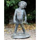 AN ANTIQUE LEAD STATUE depicting a Putti holding a bow, standing on a circular base 45cm diameter